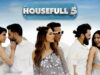 Housefull 5 Day Wise Detailed Box Office Collection | India and Overseas Elegant cast photo from the movie "Housefull 5," showcasing popular actors in stylish white outfits with a bright, sunny background for high-energy Bollywood film promotion.