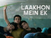 Lakhon Mein Ek Web Series & What Can Fans Expect Next? A Tired Young Man Resting His Head On His Friends' Shoulders During A Movie Scene, With The Text &Quot;Laakhon Mein Ek&Quot; Overlayed. The Image Represents The Movie &Quot;Laakhon Mein Ek&Quot; Available On Inside Box Office, Highlighting Youth And Friendship.