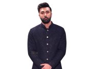 Ranbir Kapoor Stylish Man In A Black, Glittery Indian Traditional Sherwani For Formal Events Or Celebrations. Elegant Attire With A Textured Pattern, Standing Against A Plain White Background.