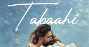 Toxic New Song Tabaahi Review: Disappointment From Yash Starrer Continues An Intense Scene From The Indian Action Thriller Film &Quot;Tabahi&Quot; Featuring A Man And Woman Embracing Each Other Against A Cloudy Sky Background.