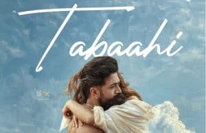 Toxic New Song Tabaahi Review: Disappointment From Yash Starrer Continues An Intense Scene From The Indian Action Thriller Film &Quot;Tabahi&Quot; Featuring A Man And Woman Embracing Each Other Against A Cloudy Sky Background.