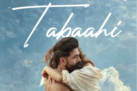 Toxic New Song Tabaahi Review: Disappointment From Yash Starrer Continues An Intense Scene From The Indian Action Thriller Film &Quot;Tabahi&Quot; Featuring A Man And Woman Embracing Each Other Against A Cloudy Sky Background.