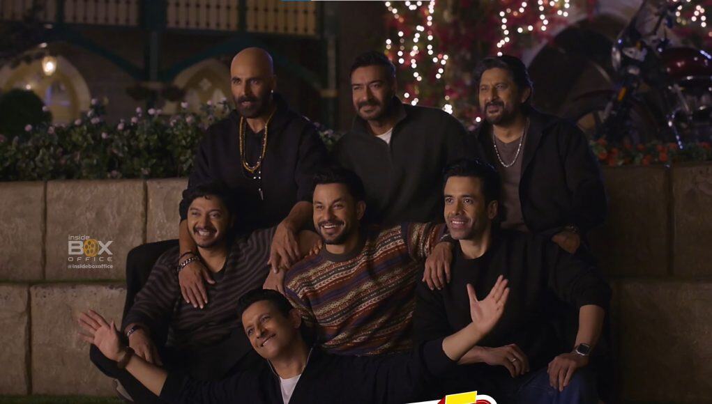Golmaal 5 Movie Cast Celebration An image of the cast of Golmaal 5, including Ajay Devgn and Akshay Kumar, celebrating together with festive lights in the background.